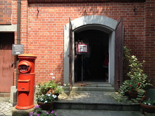 おおず赤煉瓦館（愛媛県大洲市大洲60番地）の煉瓦資料室入口と昭和30年台の円筒形の郵便ポスト