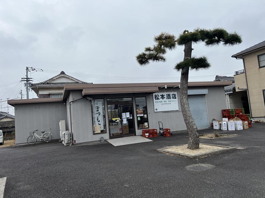松本酒店の店舗と一本松