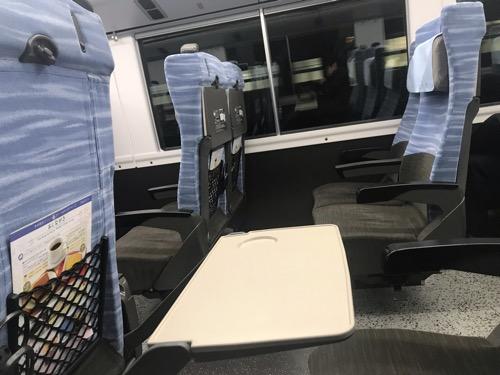 特急スーパーあずさ32号・新宿行の自由席車両（3号車）の座席のテーブルの表面と座席を横から見た様子