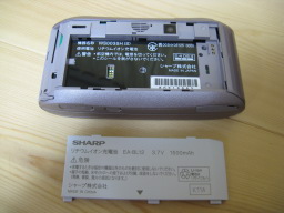 WILLCOM SHARP W-ZERO3 WS003SH(S)の本体背面よりバッテリーカバーを取り外した写真2